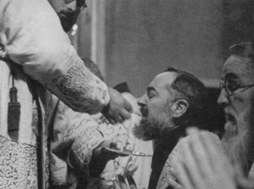 Padre Pio receiving Holy Communion