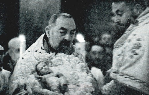 Padre Pio holding the Divine Infant