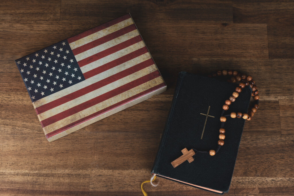 American flag with a prayer book and a rosary, vintage look and copy space