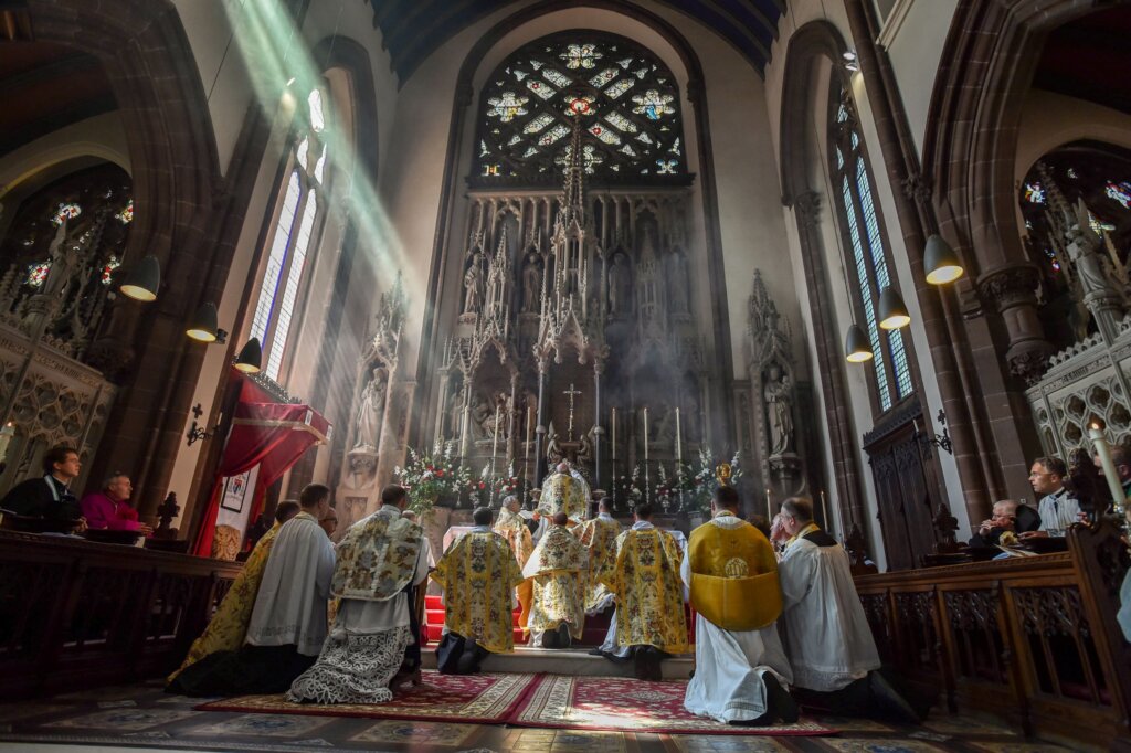 Light shines in during the ordination of Fr. Stewart (on left, in white floral vestments) at St. Mary's (photo by John Aron)