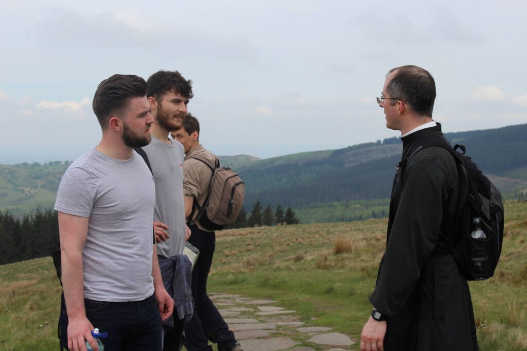 Fr. Verrier speaks with a group of young Catholics during a parish excursion to North Wales (photo by FSSP Warrington)
